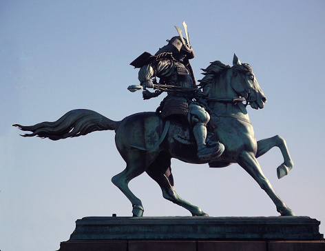  This bronze Kusunoki Masashige Statue is in the city park, outside of the Imperial Palace in Tokyo Japan. The statue was commissioned by the Japanese government around 1880 and took workers 2 years to build. Kusunoki was an ancient Japanese hero that became the patron saint of Kamikaze pilots during WWII. Saint, Kamikaze, Samurai, Statue, Patron Saint, masashige, kusunoki, Horse, Asia, Japan, Tokyo Prefecture, Traditional Culture, Power, Strength, Imperial Gardens, Kusunoki Masashige