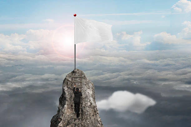 istock businessman climbing on peak with blank flag and sunlight clouds 532357353