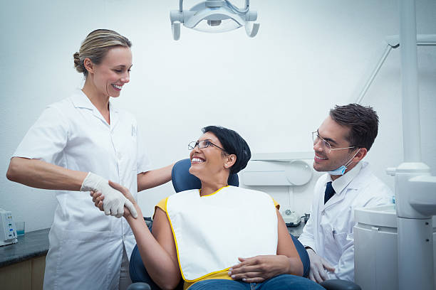 istock Male dentist with assistant shaking hands 532358405
