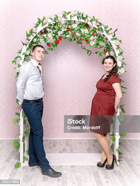 Romantic Expectant Parents Stock Photo - Download Image Now - Arch - Architectural Feature, Rose - Flower, 2015