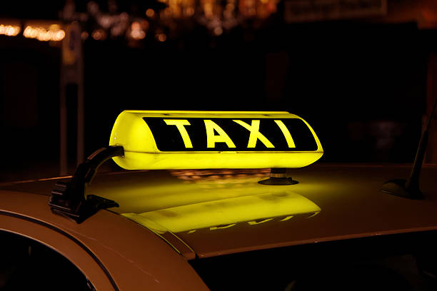 yellow taxi sign in Germany by night