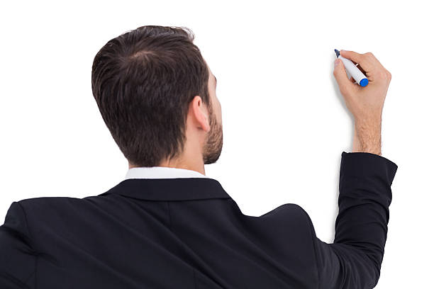 istock Rear view of businessman writing with marker 532372323