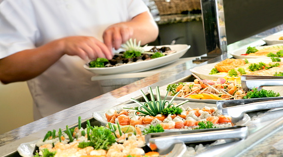 A shallow depth of field image looking along a sushi buffet bar