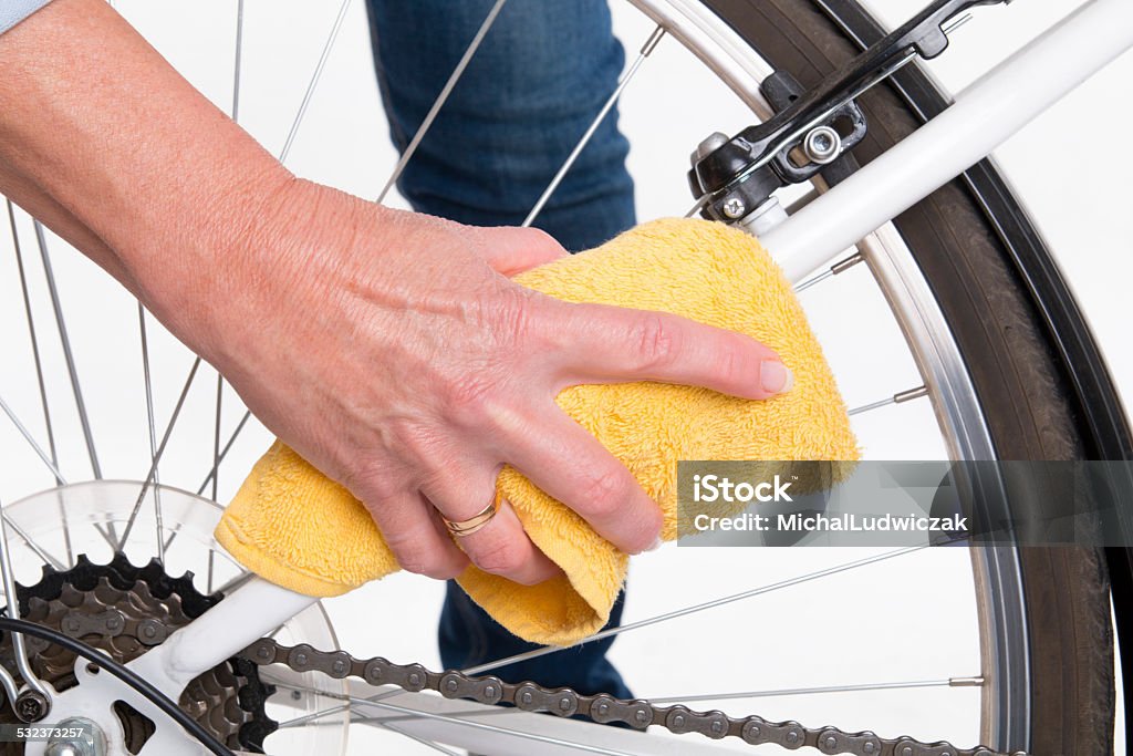 Spring cleaning of the bike frame with a cloth Spring cleaning of the bike frame with a cloth - studio shoot Cleaning Stock Photo
