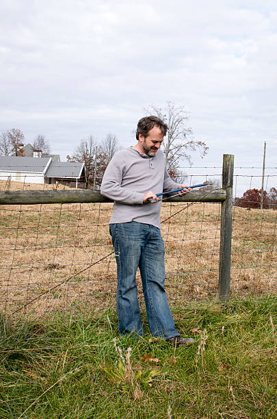 istock Rugged bearded man leaning on fence 532373657