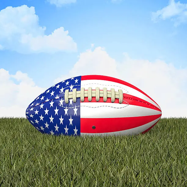 american football ball with usa flag on grass
