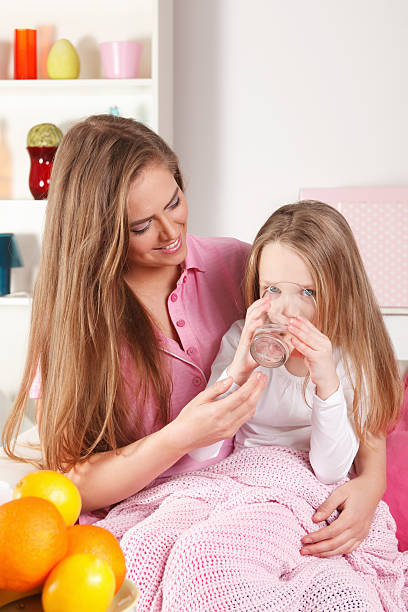 Little girl drinking water stock photo