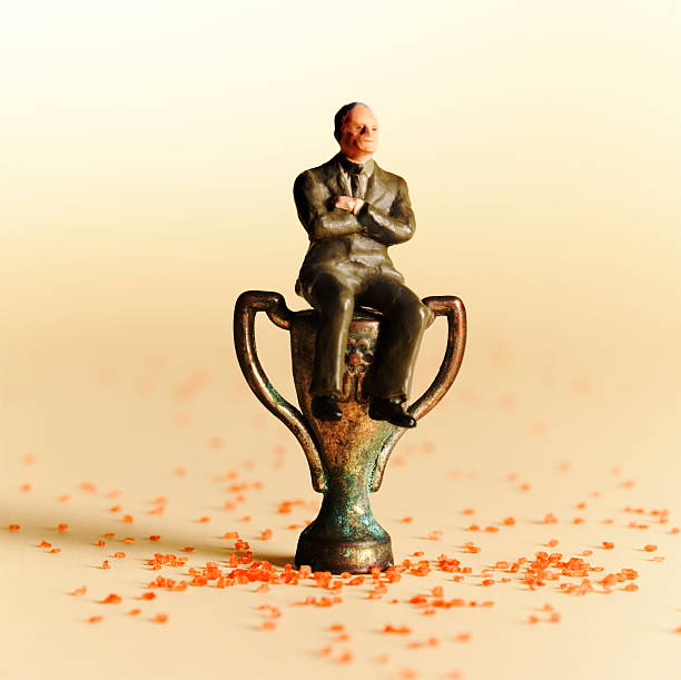 Man Sitting on Top of Trophy stock photo