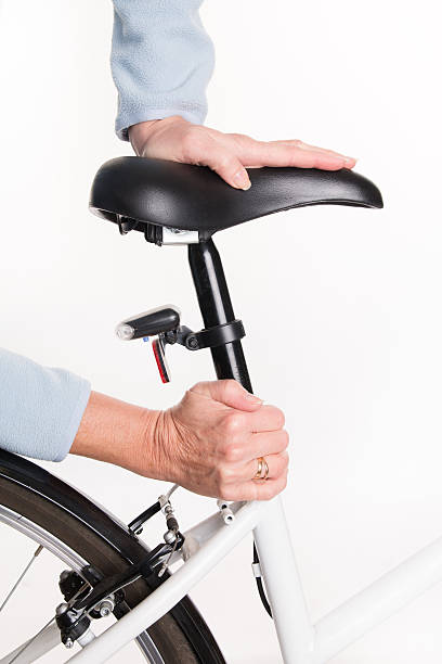 istock Woman sets height of  bicycle saddle before cycling 532378115