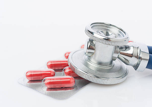 istock Stethoscope and some pills - isolated on a white background 532379349