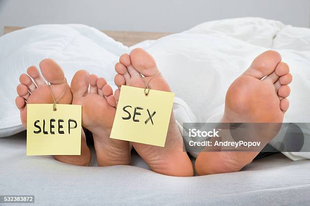 Four Feet With The Text Sleep And Sex On Label Stock Photo - Download Image Now - Adult, Bed - Furniture, Blanket