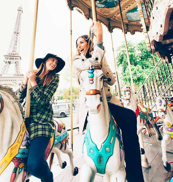 istock Laughing young women having fun on marry-go-round at Eiffel Tower 532384694