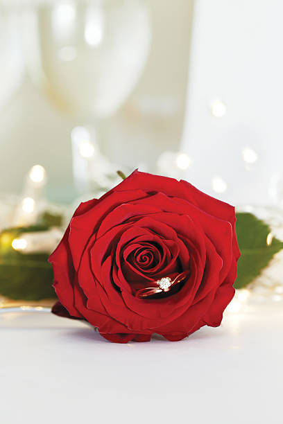 istock wedding gold ring with diamond and rose flowers 532386624