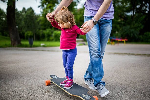 istock Cute girl learn to ride a skateboard 532386690