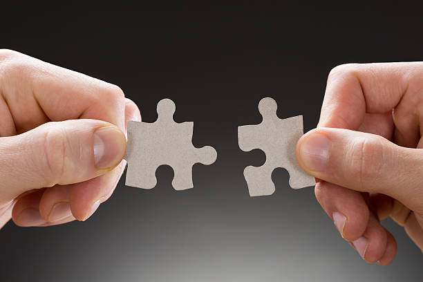 istock Close-up Of Hands Holding Jigsaw Pieces 532387802