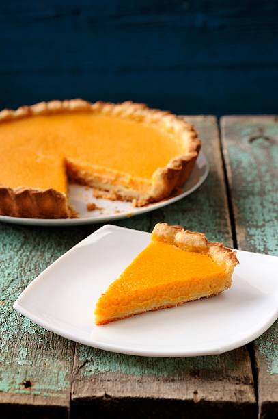 istock Homemade oldfashioned round pumpkin pie on old table painted blue 532389372