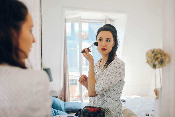 istock Young Parisian woman putting make up on 532389792