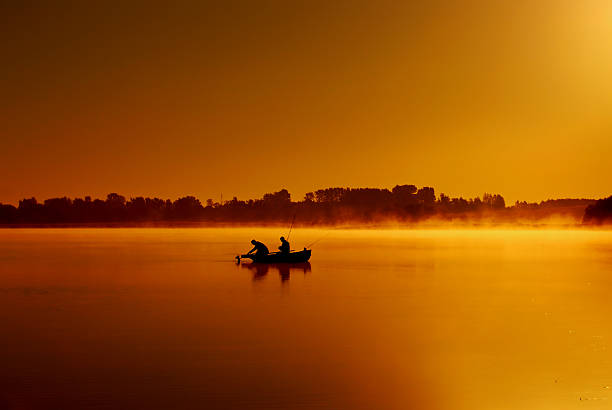 istock Dawn on the lake. Fishermen catch fish 532392000