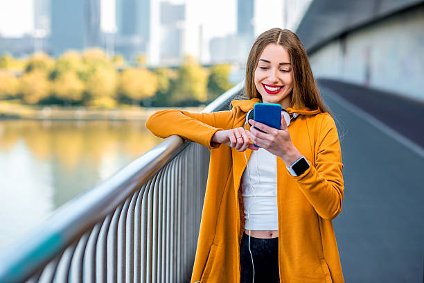 istock Woman with phone on the modern bridge 532392810
