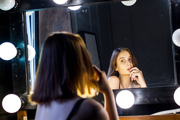 istock sexy girl admires itself in mirror 532392872
