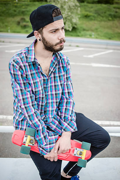 istock Stylish young guy on a red skateboard 532392978