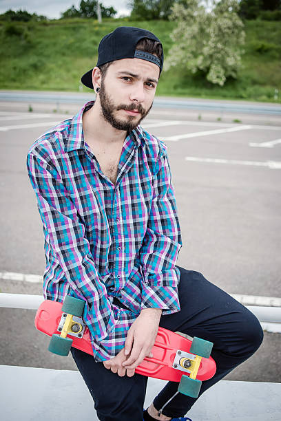 istock Stylish young guy on a red skateboard 532393270