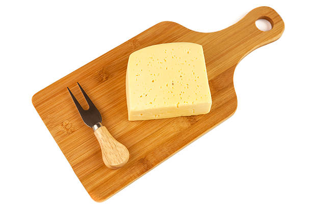 istock Block of cheese on cutting board with a knife 532393608