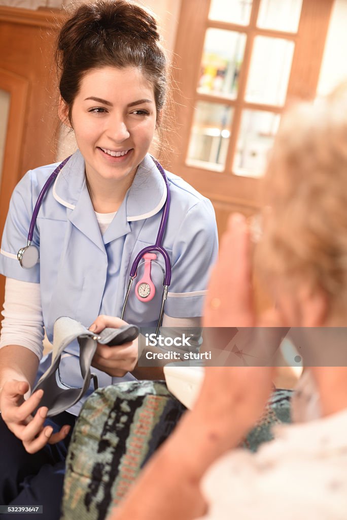 home visit blood pressure health check Home Caregiver Stock Photo