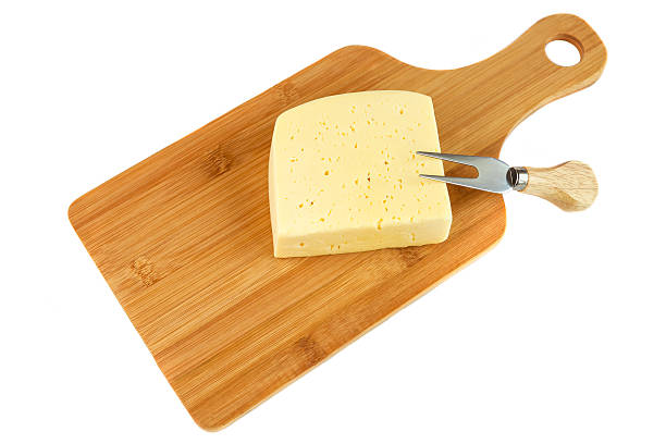istock Block of cheese on cutting board with a knife 532393764