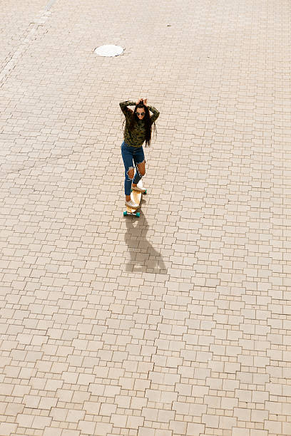 istock Happy girl with longboard skateboard 532393988
