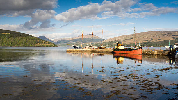 Vital Spark at Inveraray Inveraray, Scotland - May 13, 2016: The Vital Spark, a famous "Clyde Puffer" boat, is moored at Inveraray Pier in Loch Fyne in the West Highlands of Scotland. loch fyne stock pictures, royalty-free photos & images