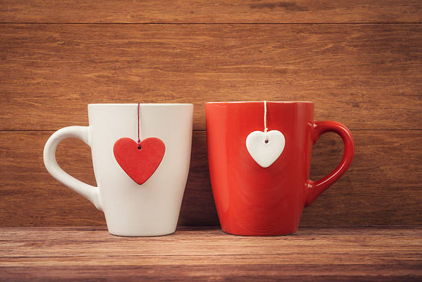 istock Cup with heart shapes over wooden background 532395037