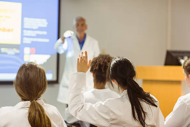 Science professor giving lecture to class Science professor giving lecture to class at the university scientific exploration stock pictures, royalty-free photos & images