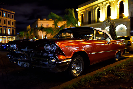 Havana, Cuba - June 5, 2015: An old Dodge Coronet in Havana Cuba, shot at night in Old Havana.
