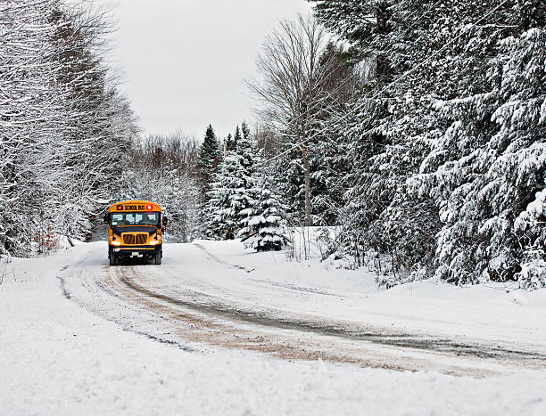 istock School Bus Driving Down A Snow Covered Road 532395571