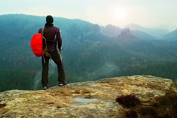 istock Hiker with backpack,  misty and foggy spring valley 532395766