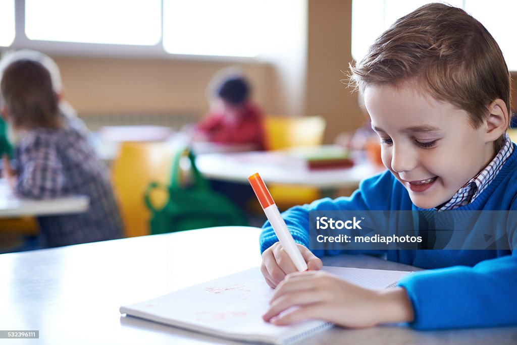 Enjoying studying Elementary student sketching in notebook 2015 Stock Photo