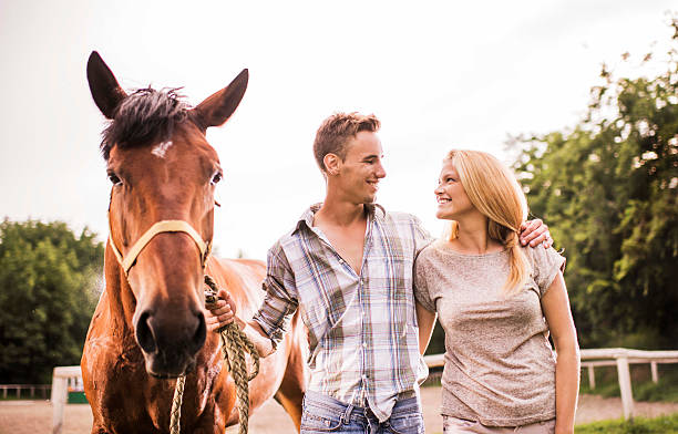 istock Embraced smiling couple with horse. 532396897
