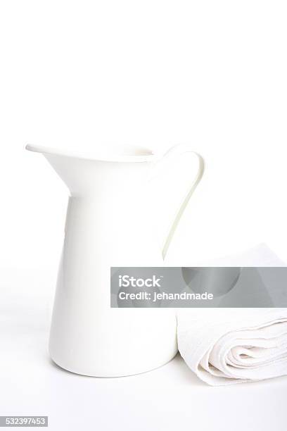 Enamelled Metal Jug On White Background And Cotton Towel Stock Photo - Download Image Now