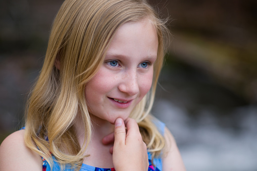 Outdoor Portraits of Little Girl - Age 7-12 girl smiling in scenic outdoor area along mountain creek.