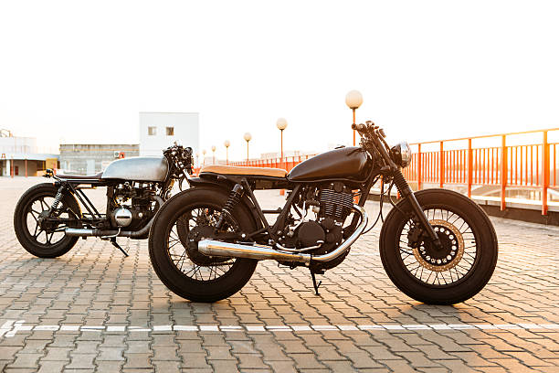 istock Two black and silver vintage custom motorcycles caferacers 532400604