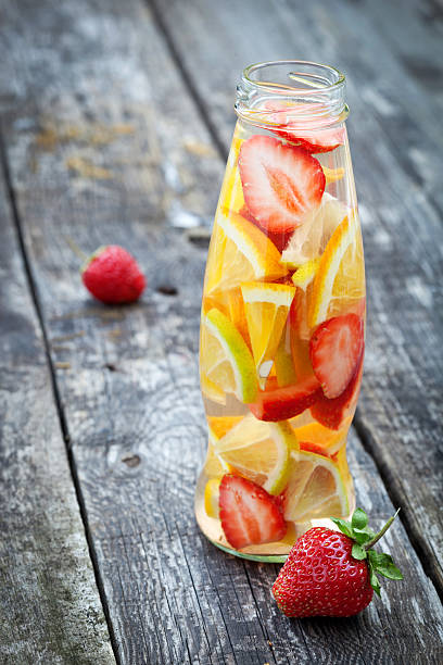 istock Fresh fruit detox water in bottle on wooden table 532400731