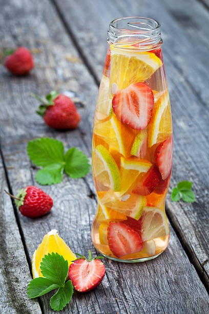 istock Fresh fruit detox water in bottle on wooden table 532400755