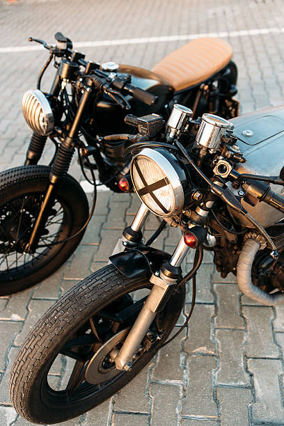 istock Two black and silver vintage custom motorcycles caferacers 532400858