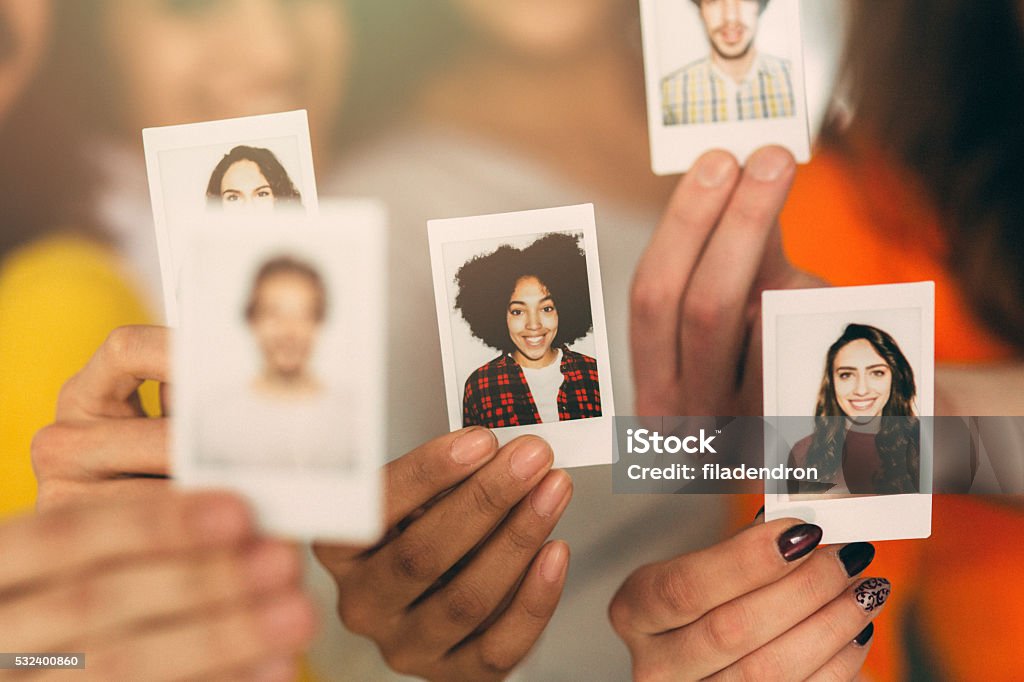 Human Resources A group of people holding photos of themselves. Community Stock Photo