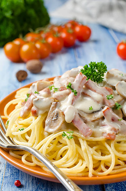 istock Spaghetti with Bechamel sauce, mushrooms and bacon 532404226