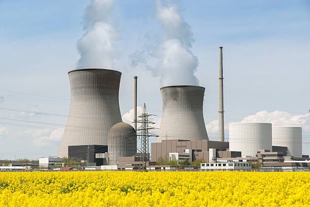 istock Nuclear power plant with yellow field and big blue clouds. 532404400