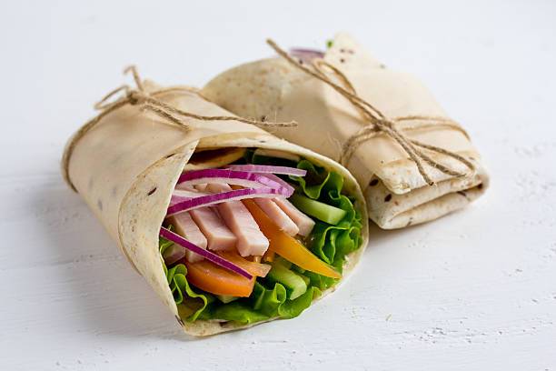 istock Homemade Burritos with vegetables, ham and tortilla 532408578