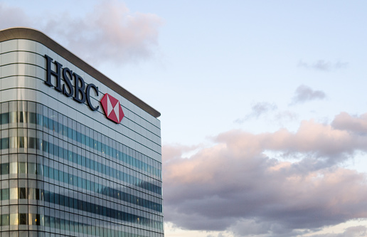 London, England - February 27, 2015: The HSBC logo tops a skyscraper that houses the HSBC global headquarters in London's Docklands business district.