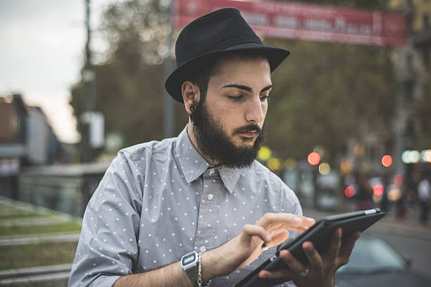 istock young handsome hipster gay modern man using tablet 532410747